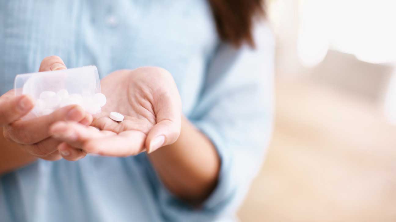 Pill in Palm of Woman's Hand