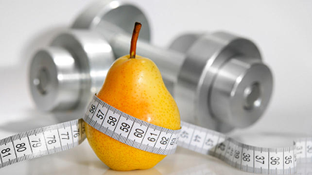 pear with weights wrapped in measuring tape