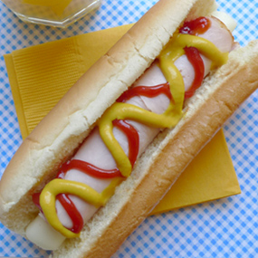 String cheese stick wrapped in turkey and served on a hotdog bun