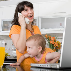 Mom on phone in kitchen.