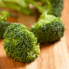 Broccoli on a cutting board.