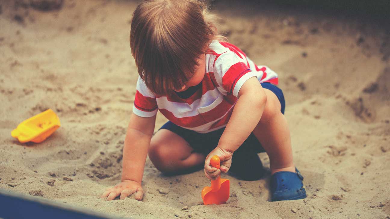 kid playing in the sandbox 