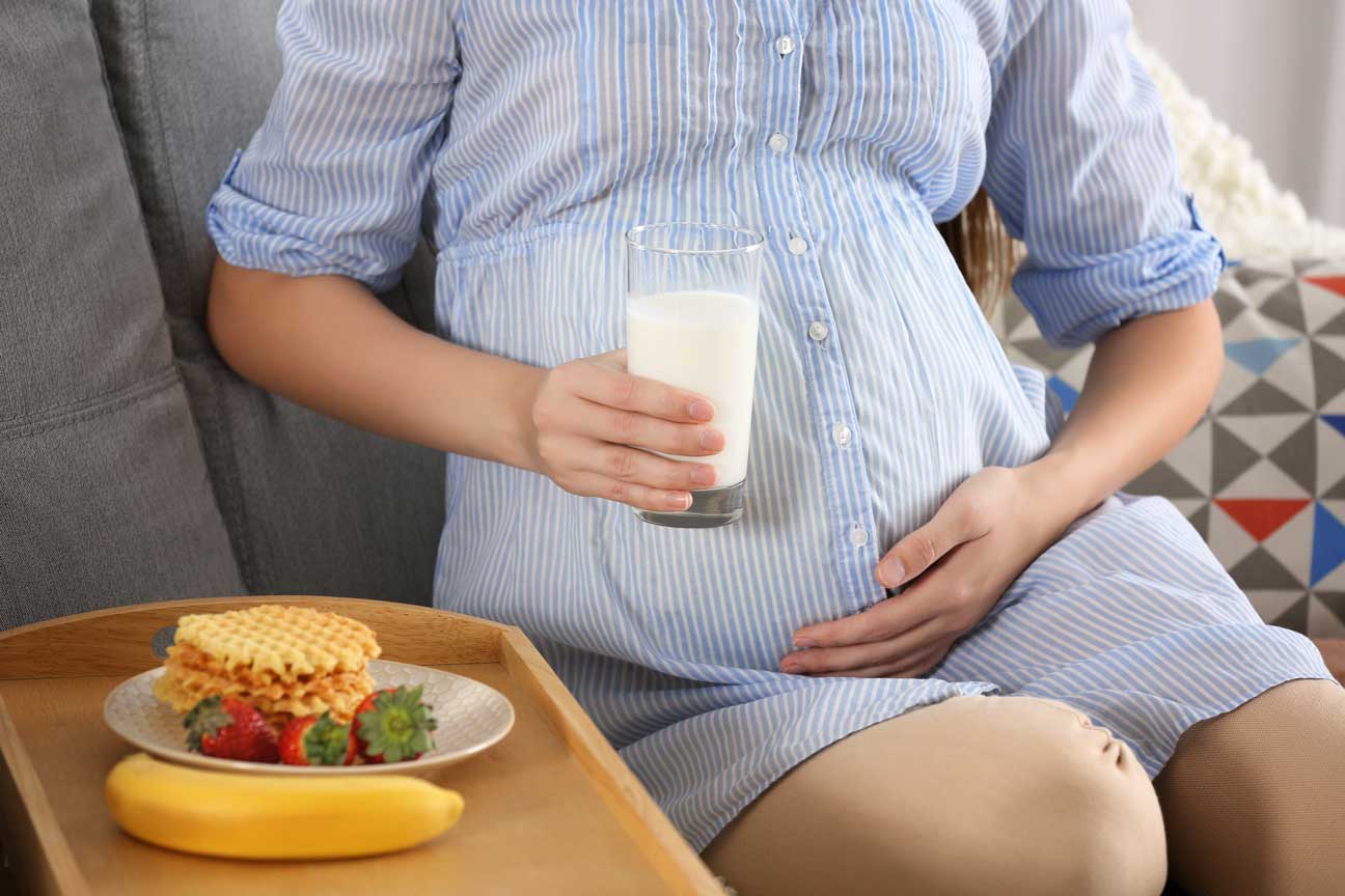 Pregnant woman with glass of milk