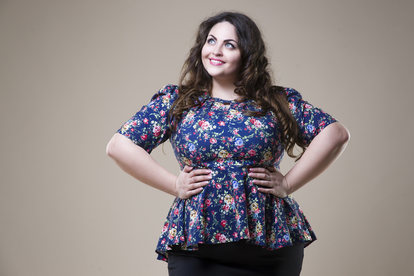 Smiling Plus Size Woman With Hands on Waist